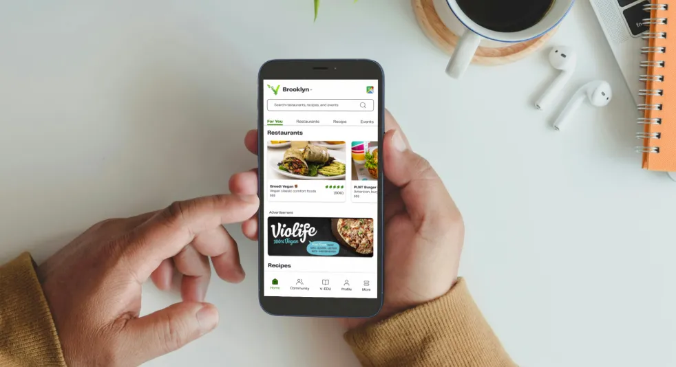 Person exploring vegan food options on a search and discoverability app for restaurants, recipes, and events